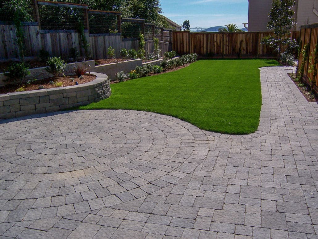 Driveway with pavers with grass alongside of it