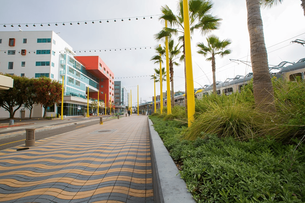 Picture of pavers installed on a driveway with buildings and grass alongside